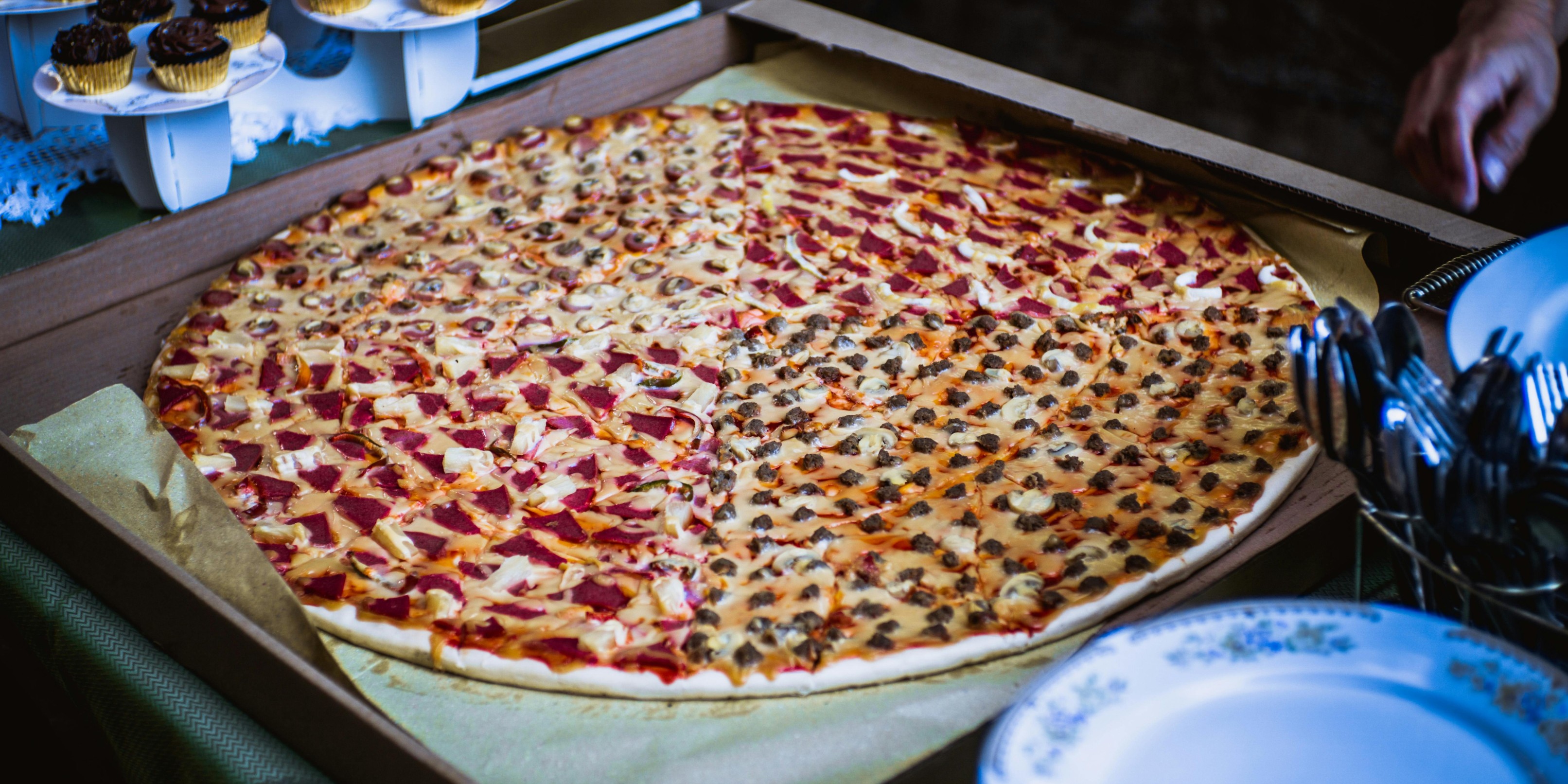 A-large-pizza-with-various-toppings-displayed-in-an-open-box-showcasing-its-delicious-slices